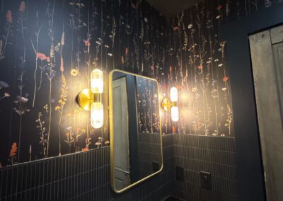 Bathroom remodel with floral wallpaper vanity and brass accents