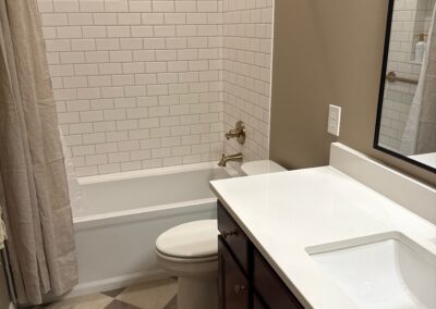 Bathroom remodel with vanity, shower, and brass fixtures